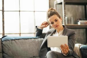 thoughtful business woman using tablet pc in loft apartment
