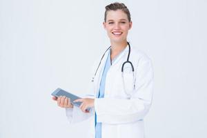 Happy doctor holding tablet pc photo