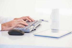 Businessman hands typing on keyboard photo