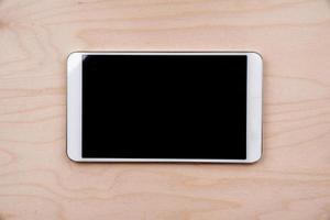 Tablet PC on wooden background photo