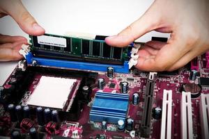 Man installing memory. PC motherboard RAM upgrade photo