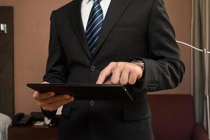 Young businessman working by using tablet. photo