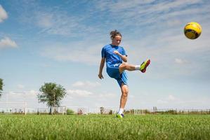 girl kicking soccer ball photo