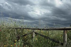 Wooden Fence and Cloudy Sky photo