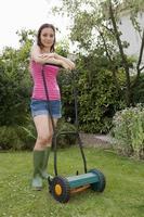 Woman with lawn mower photo