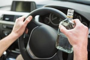 Close up of driver holding vodka