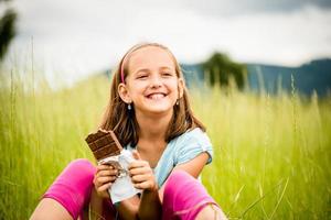 Girl enjoying chocolate photo