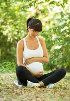 Pregnant woman's sitting in a position lotus