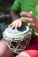 Man playing the hand drums in nature photo