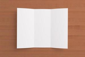 Blank tri fold brochure on wooden background