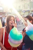 young women eating cotton candy and enjoying