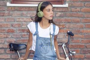 young beautiful woman enjoys music with headphones photo