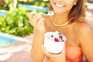 Young African American Woman Enjoying Frozen Yogurt photo