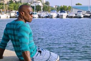 Handsome black man relaxing and enjoying the summer. photo