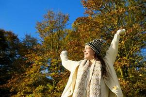 mujer feliz sonriendo y disfrutando de un día de otoño al aire libre foto