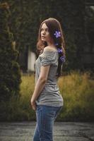 young beautiful woman outdoors in garden  at sunset,  flowers in  hair