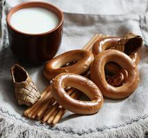 food milk in a glass straw bagels and pretzels photo