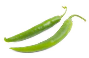 Two green chili peppers on white