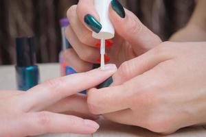 Oil cuticles, stage of manicure process photo