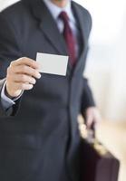 Businessman Holding Business Card In Office