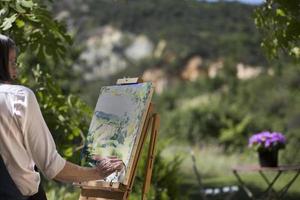 Woman painting at an easel photo