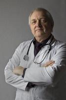 Mature doctor with stethoscope photo