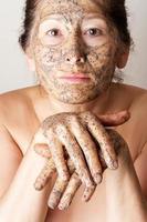 Mature woman making cosmetic mask photo