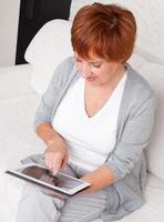 Mature woman with tablet pc photo