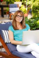 Modern mature woman portrait with laptop photo