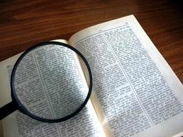 book and magnifying glass