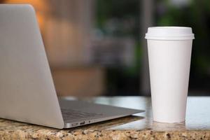 Lap top and coffee cup photo