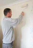 decorador pintando una propiedad residencial con un rodillo foto