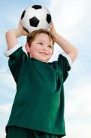 Young boy playing soccer photo
