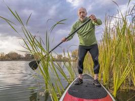 stand up paddling on a lake photo