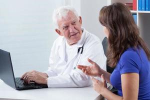 Woman visiting experienced physician photo