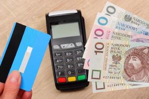Polish currency and credit card with payment terminal, finance concept photo
