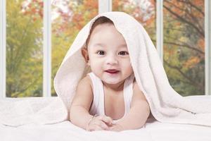 Cheerful male infant in the bedroom photo