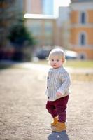 Toddler boy walking outdoors photo