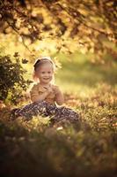 Adorable Toddler Smiling Girl Sitting in The Park