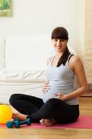 Gravid woman taking break from fitness exercises