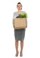 tired woman employee dragging box with personal items photo