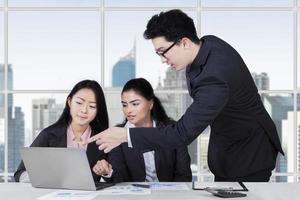 Male trainer explaining a job in office photo