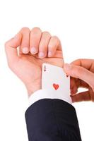 Businessman with ace card hidden under sleeve.