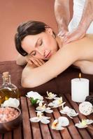 Woman Receiving Back Massaging In Spa