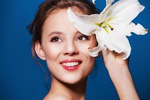 Beauty portrait of attractive, fresh woman with the lily flower