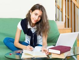 Teenager girl doing homework photo