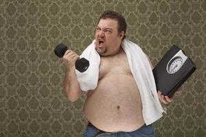 Hombre con sobrepeso sosteniendo escalas trabajando duro para perder peso