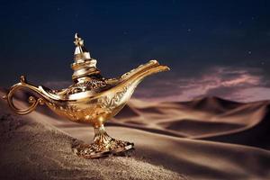 Magic Aladdin's Genie lamp on a desert photo