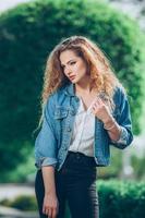 Beautiful young Caucasian girl with curly hair outdoors