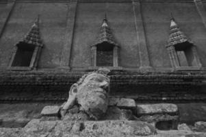 Ancient buddha head statue at ruin of underwater temple photo
